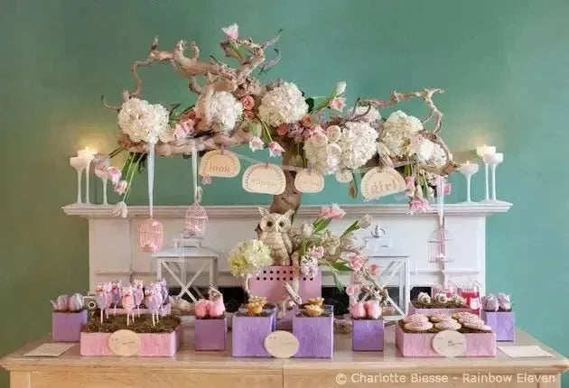 Elegant baby shower dessert table with pastel decorations, flowers, and sweet treats