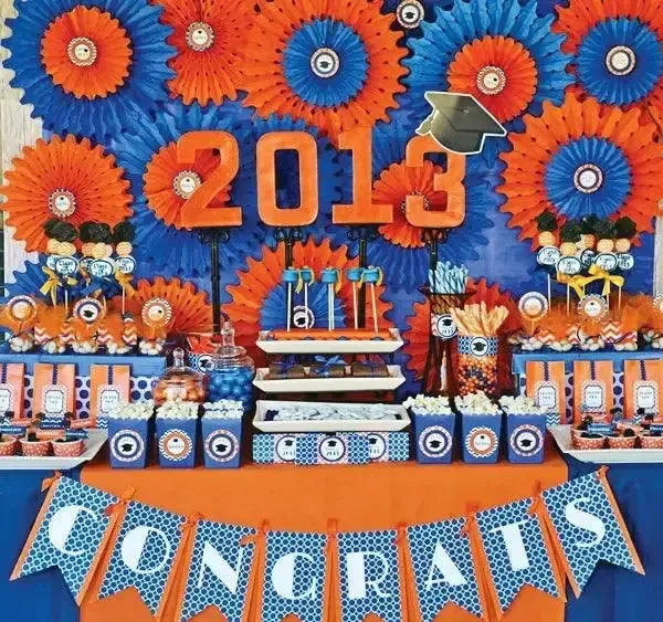 Graduation party table with orange and blue 2013 decor, treats, and a congratulatory banner