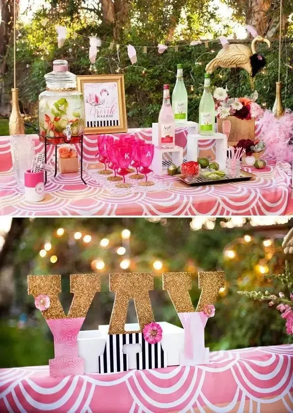 Flamingo themed girls fiesta table with pink decor, drinks, party glasses and gold accents outdoors