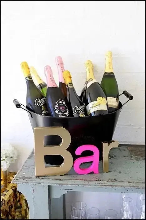 Champagne bottles in ice bucket with Bar sign at 40th birthday party setup