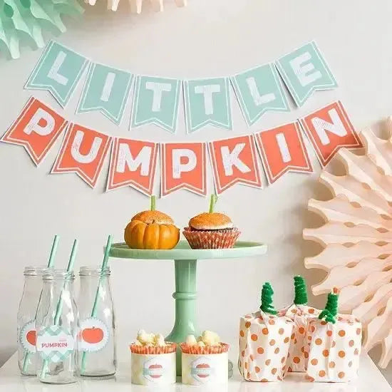 Little pumpkin party decor with pumpkin desserts, milk bottles, and pastel banner.