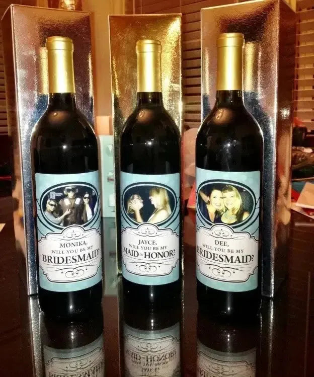 Three wine bottles with custom labels asking will you be my bridesmaid or maid of honor
