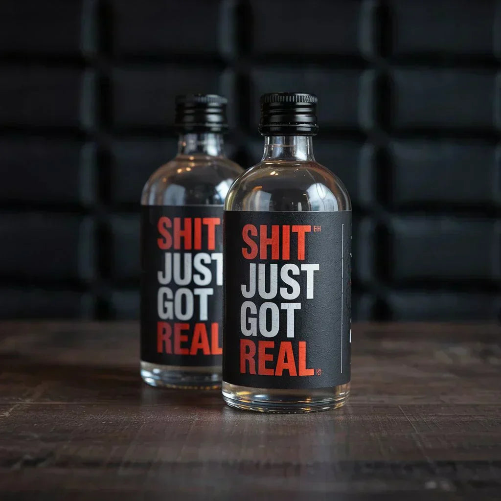 Custom mini liquor bottles with bold party-themed labels on a wood table