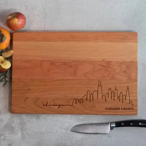 Personalized wooden cutting board with engraved Chicago skyline and custom names
