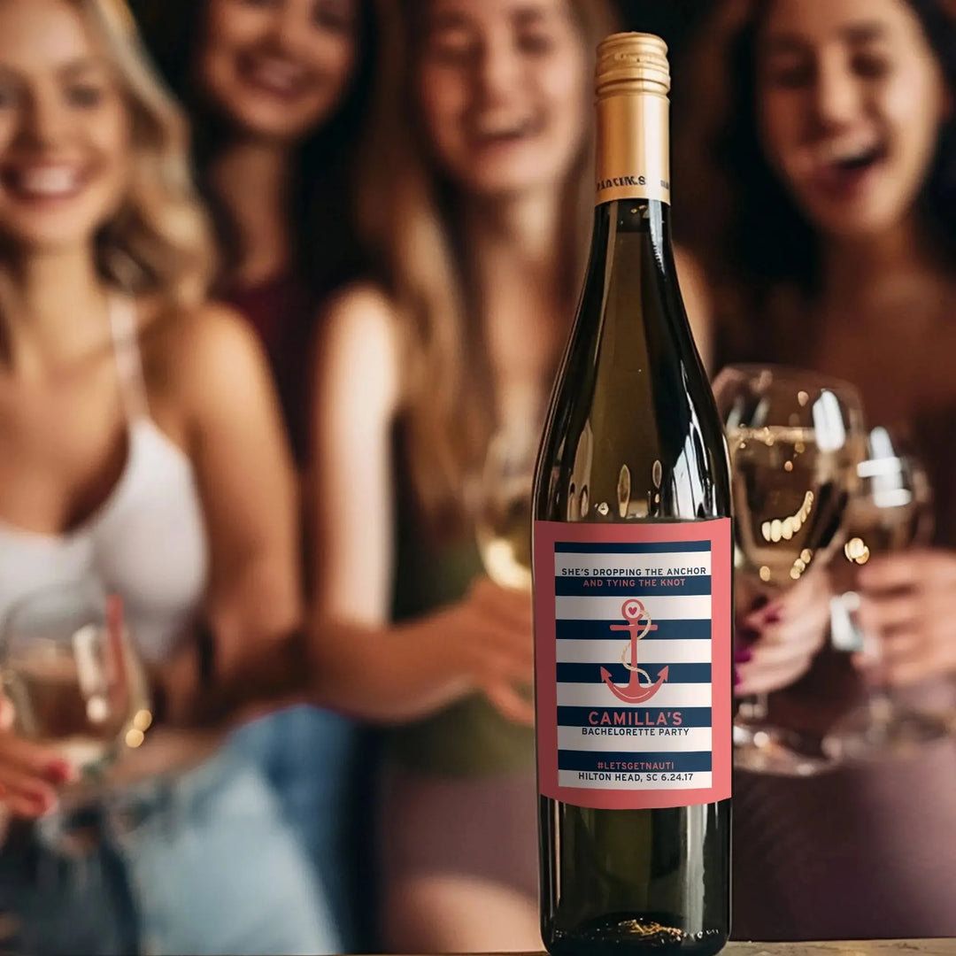 Custom bachelorette wine label on bottle, women celebrating with wine in background