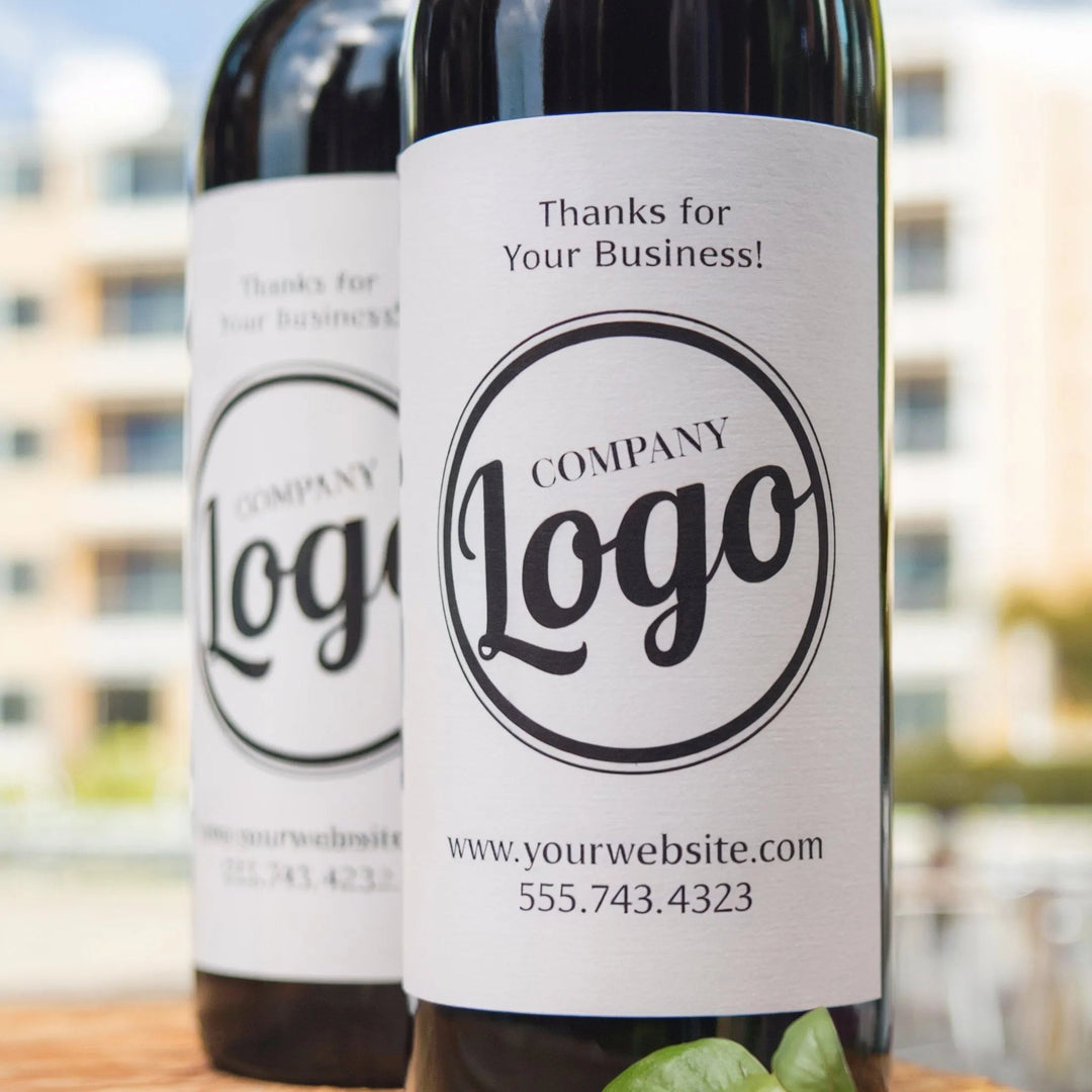 Custom business wine bottle label with company logo and contact details outdoors