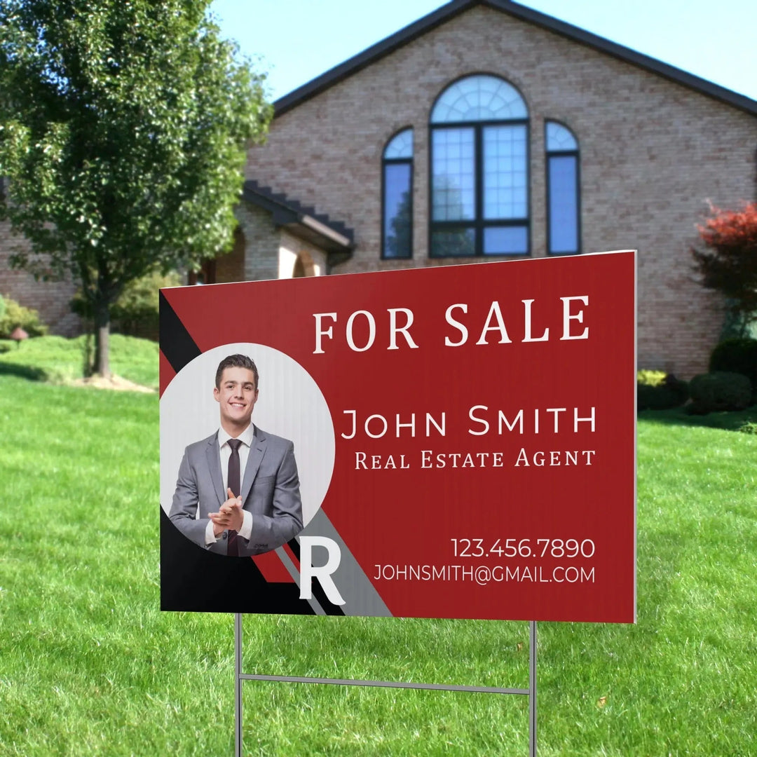 Custom real estate yard sign for sale in front of a house, featuring agent photo and contact info.