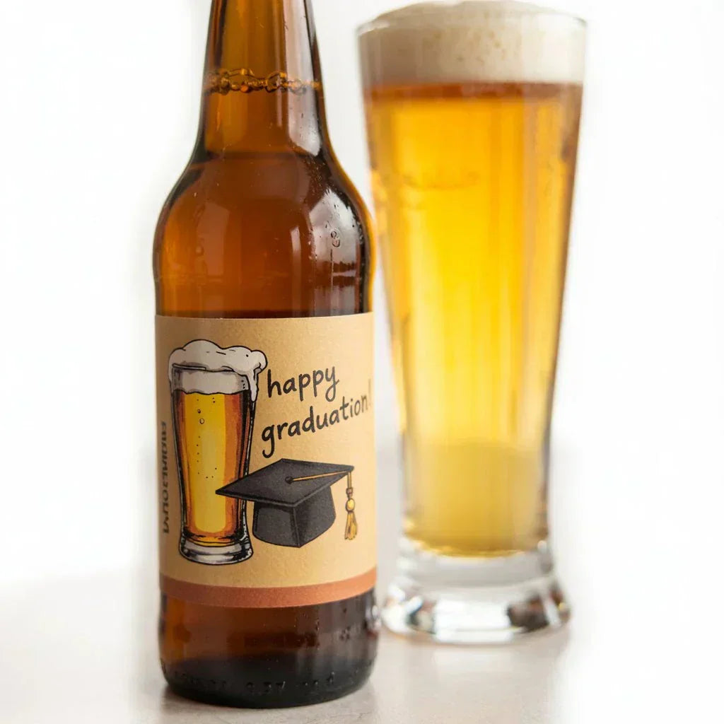 Graduation beer bottle with custom label and glass of beer, happy graduation text, cap graphic