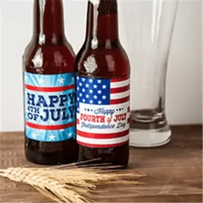 Custom Fourth of July beer labels with American flag designs on bottles, festive setting