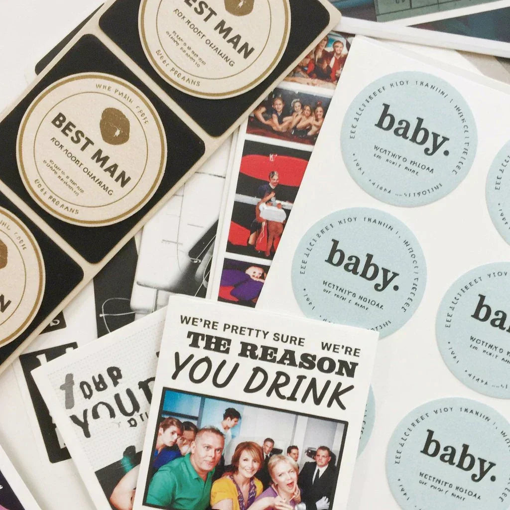 Custom labels and personalized stickers with text designs and photos on a flat surface.