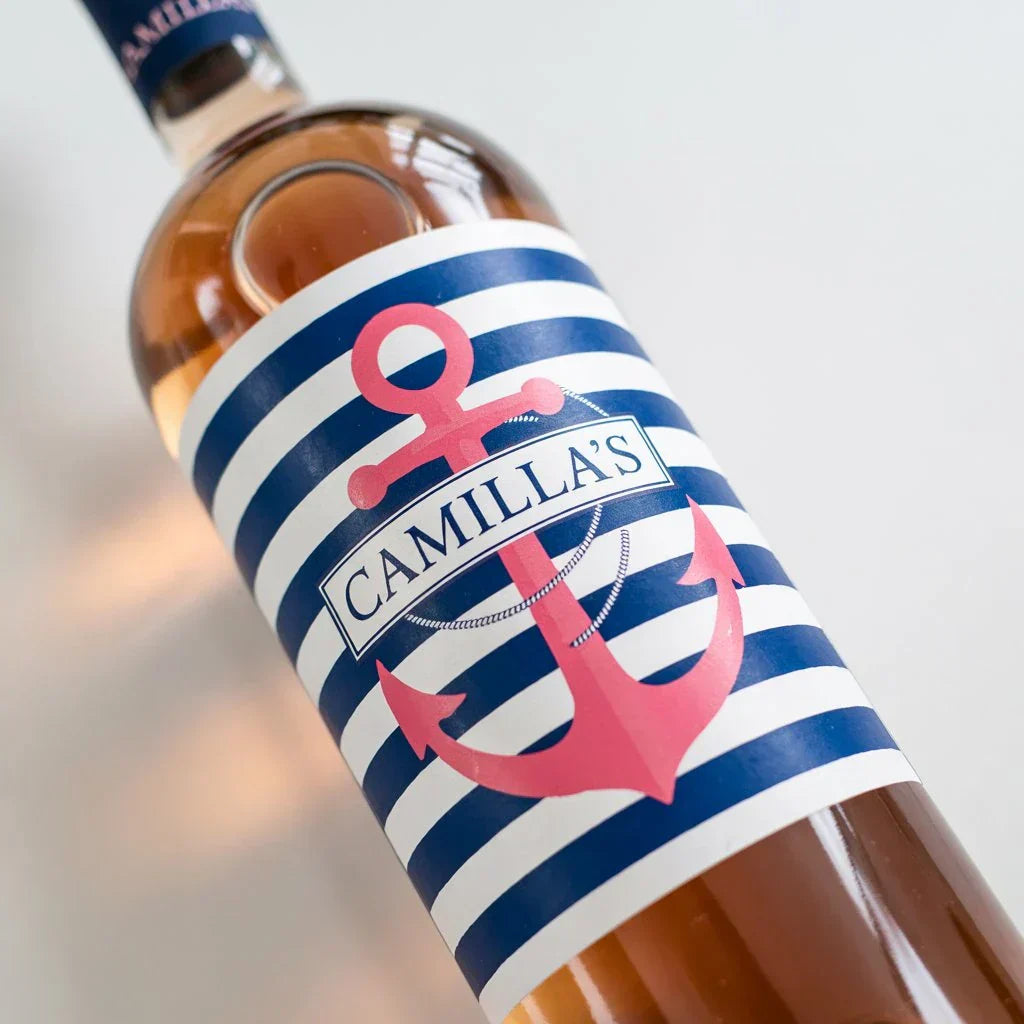 Custom wine bottle with blue striped label featuring pink anchor and personalized name