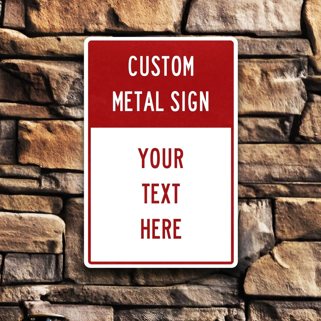 Custom metal sign with red and white design mounted on a stone wall