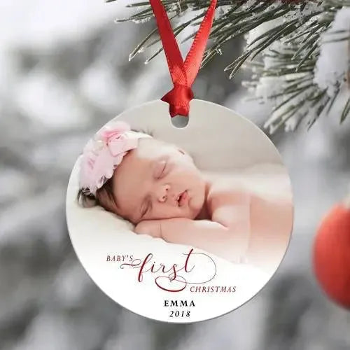 Personalized baby's first Christmas ornament with sleeping baby photo, red ribbon, hanging on tree