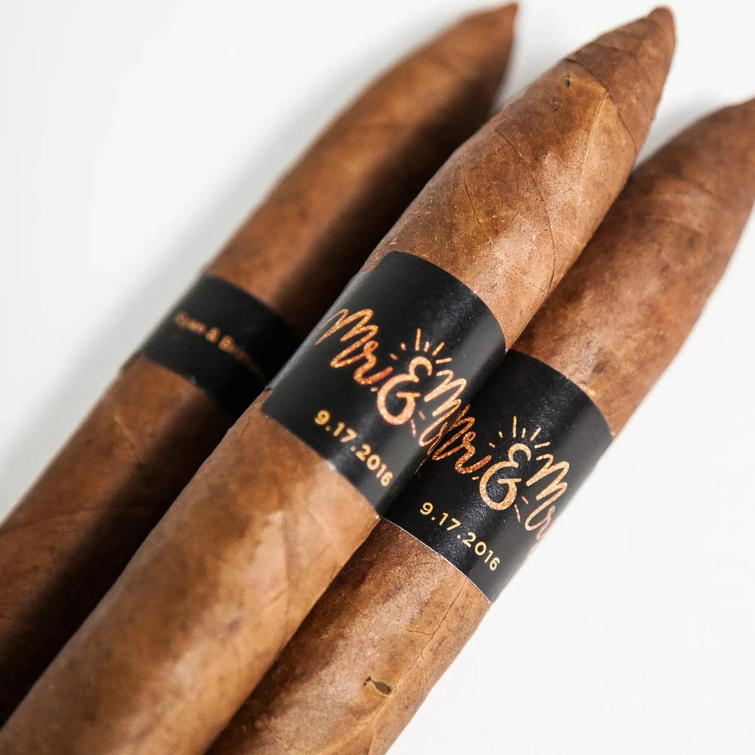 Custom wedding cigar bands with Mr & Mrs design on brown cigars for groomsmen and guests