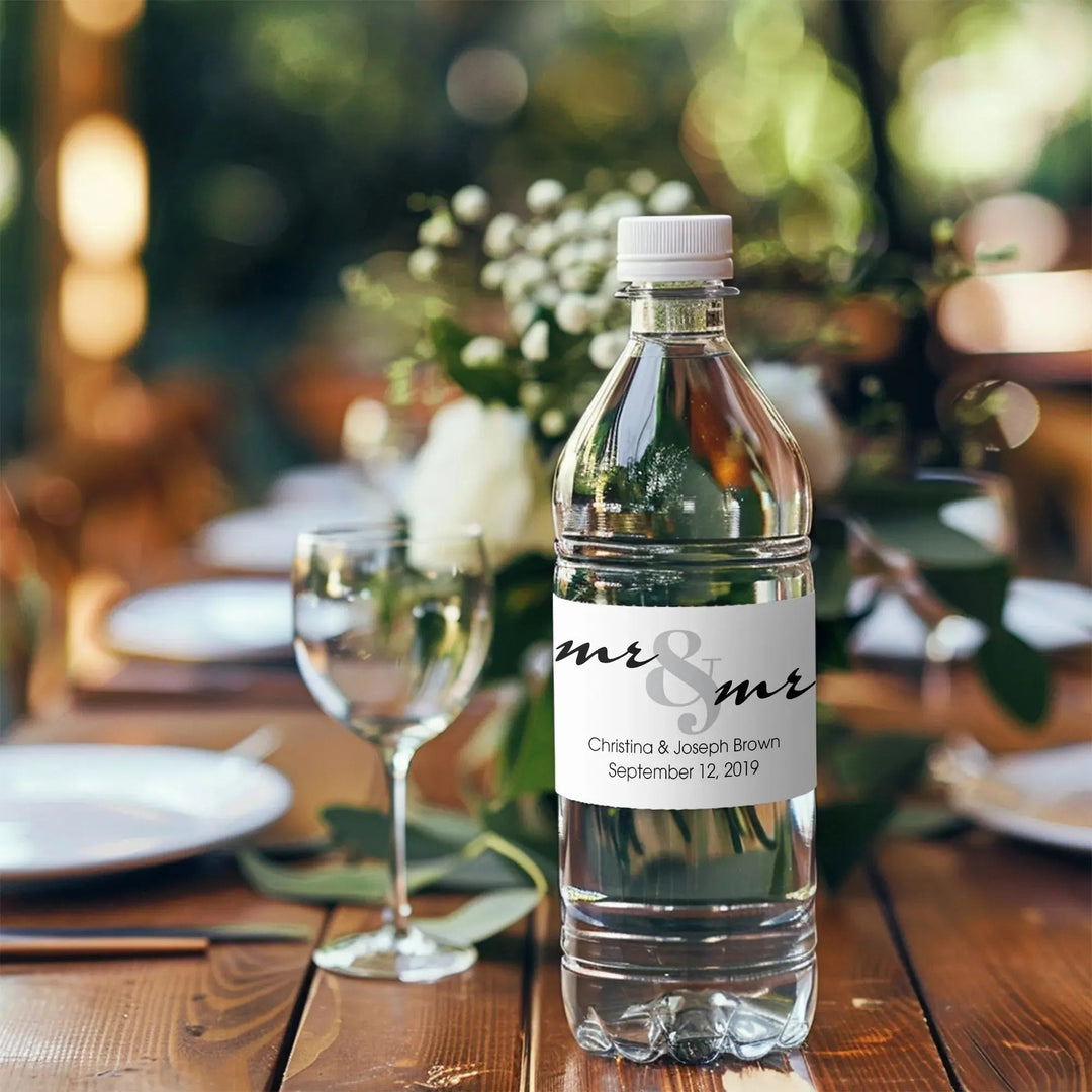 Custom wedding water bottle label on clear bottle at rustic table setting with flowers