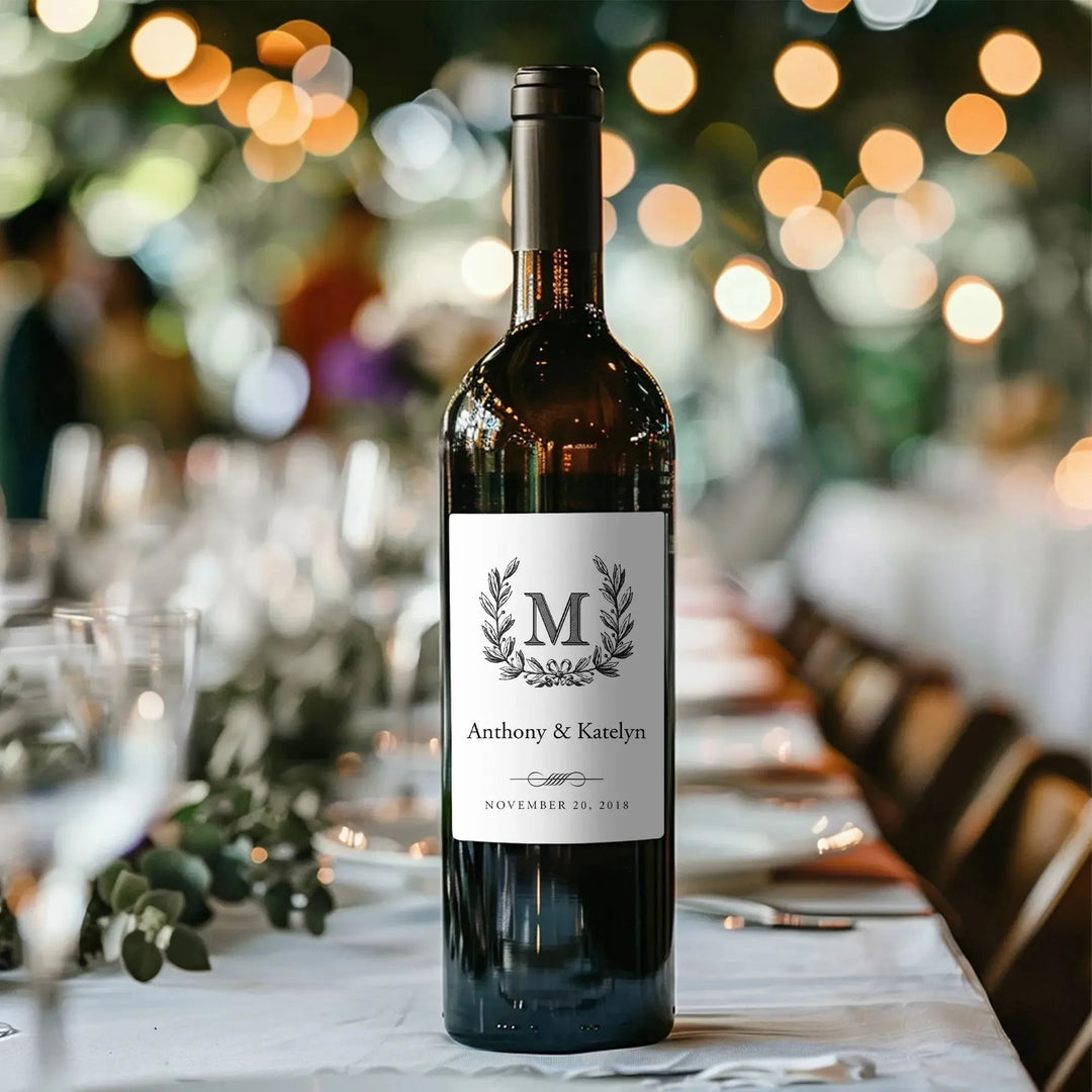 Custom wedding wine label on bottle with monogram and date, elegant table setting