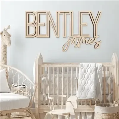 Personalized wooden nursery name sign above baby crib in neutral kids room decor
