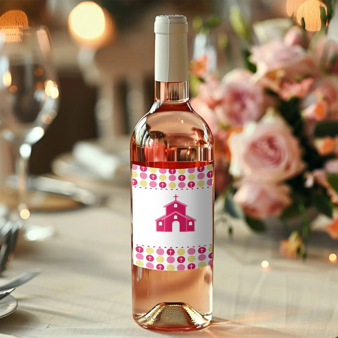 Rosé wine bottle with personalized baptism label on elegant floral table setting