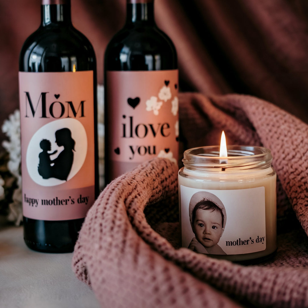 Personalized Mother's Day gifts with custom wine bottles and photo candle on pink blanket