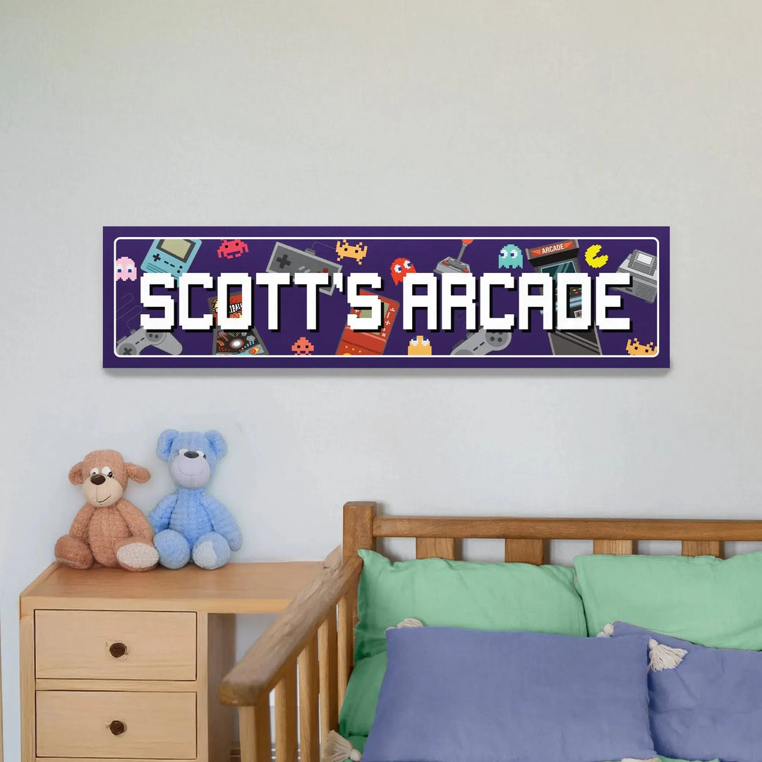 Purple metal sign with white pixel font reading 'Scott's Arcade' featuring retro gaming icons above a wooden bed with colorful pillows