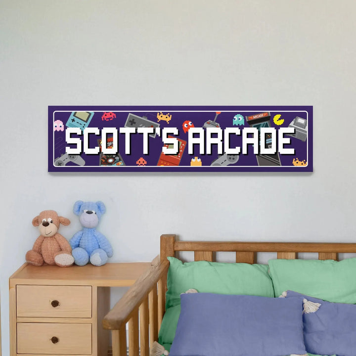 Purple metal sign with white pixel font reading 'Scott's Arcade' featuring retro gaming icons above a wooden bed with colorful pillows