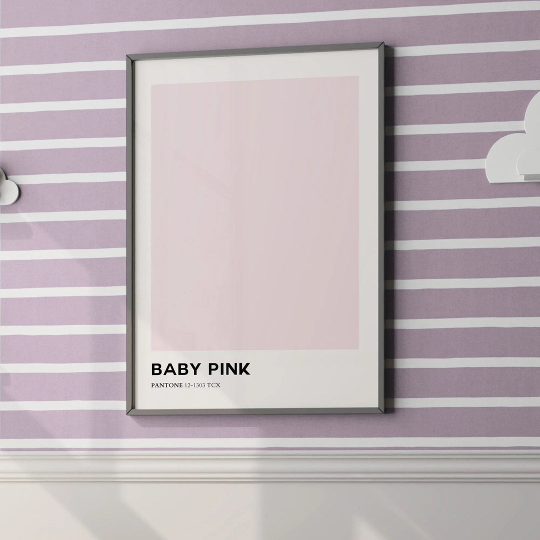 Framed baby pink Pantone wall art on purple and white striped nursery wall with white molding