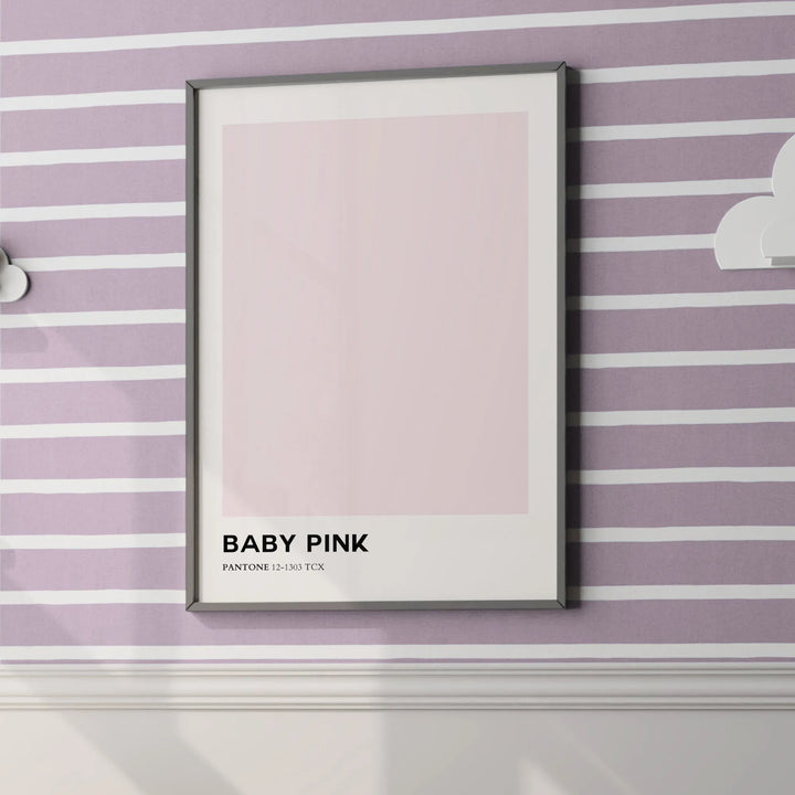 Framed baby pink Pantone wall art on purple and white striped nursery wall with white molding