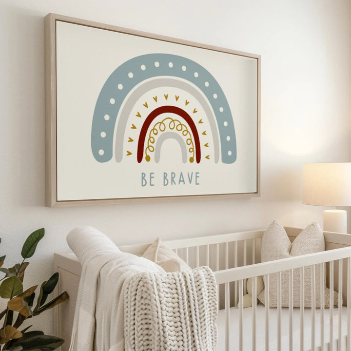Modern nursery with white crib, cozy knitted blanket, and colorful Be Brave rainbow wall art