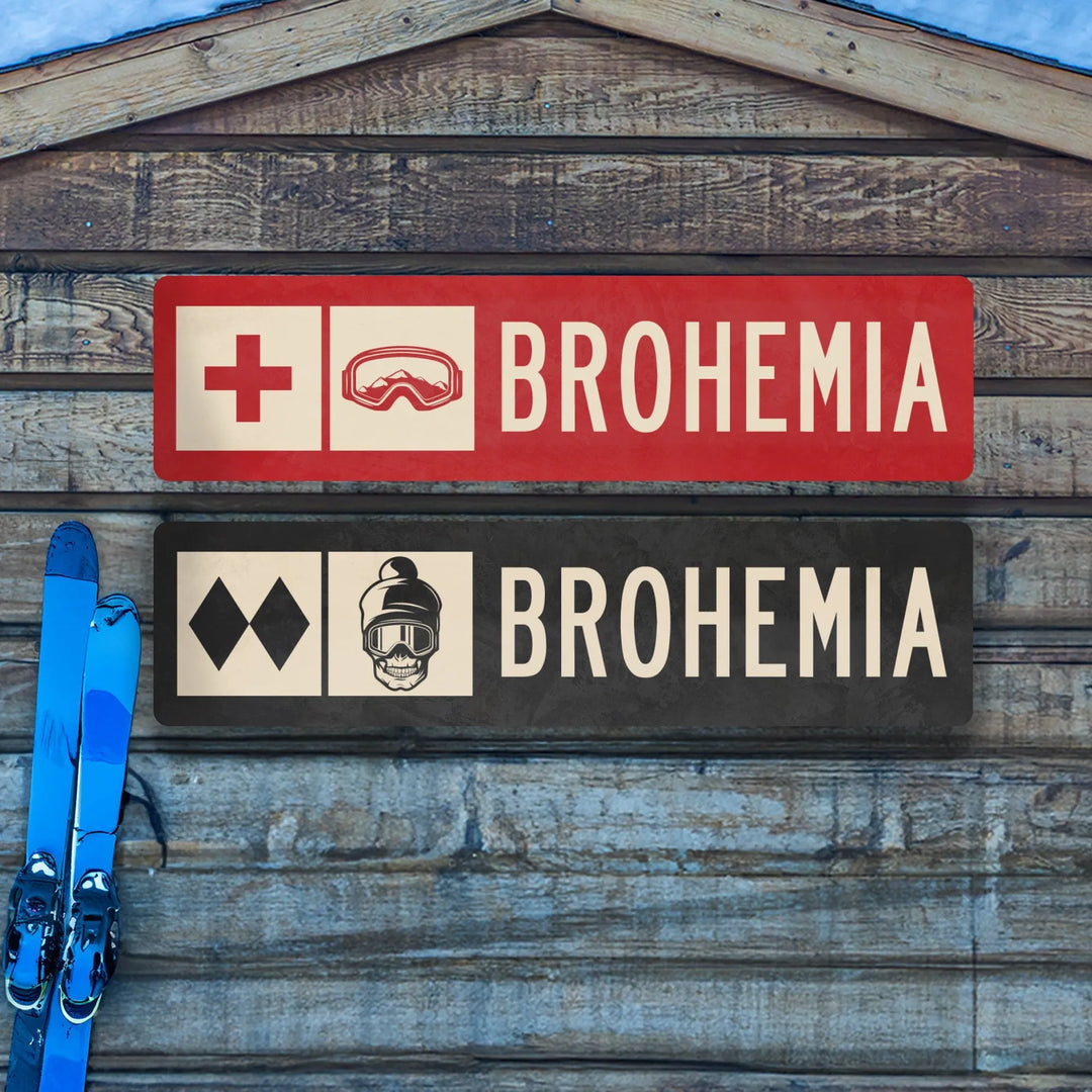 Two Brohemia ski trail metal signs on wooden wall with blue skis nearby