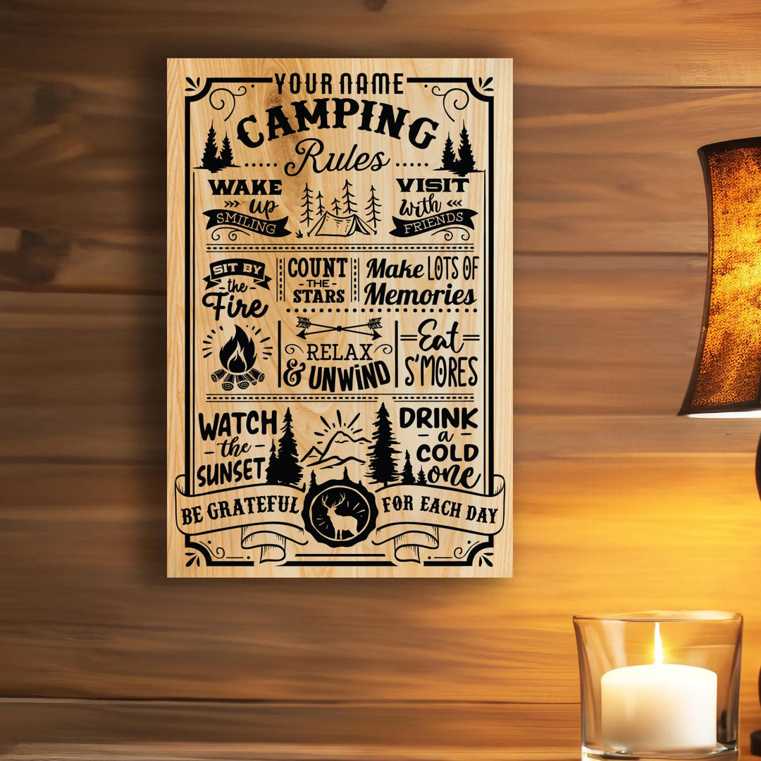 Wooden camping rules sign with black text and icons, lit candle and lamp nearby on wood background