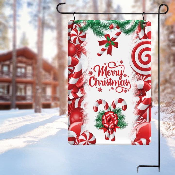 Festive Merry Christmas garden flag with candy canes, red bows, and peppermint decorations in snowy outdoors
