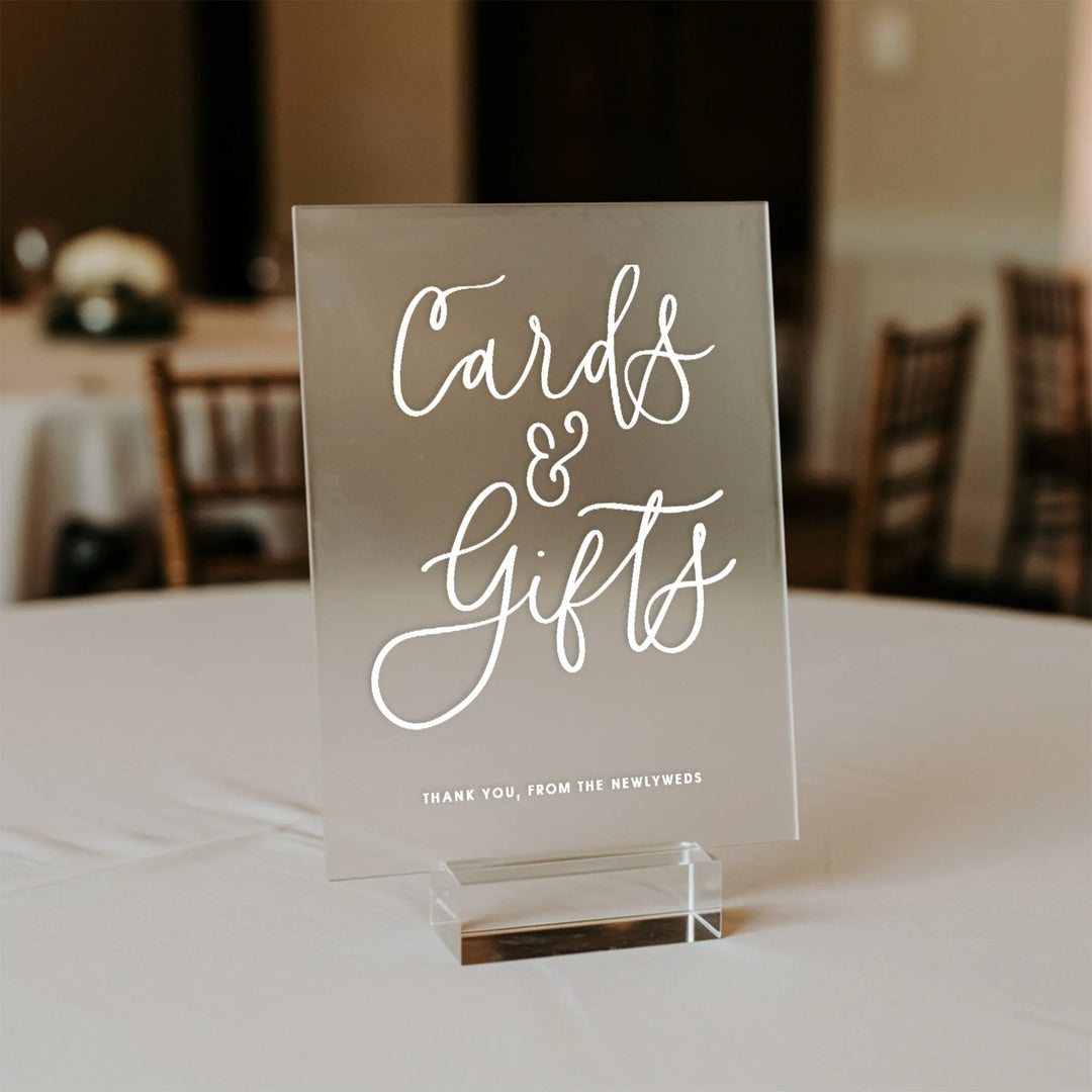 Elegant acrylic wedding table sign reading 'Cards & Gifts' in white script on a banquet table