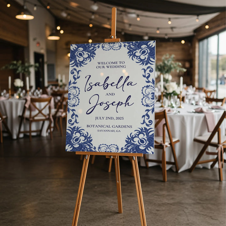 Blue floral wedding welcome sign for Isabella and Joseph at Botanical Gardens on an easel in rustic reception