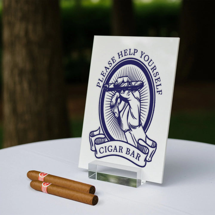 Cigar bar table sign with hand holding cigar illustration and two cigars on white tablecloth