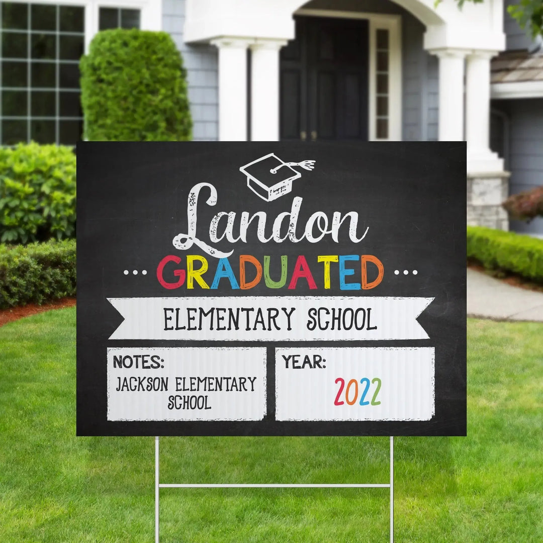 Colorful chalk style graduation yard sign for Landon, elementary school graduate 2022, on green lawn