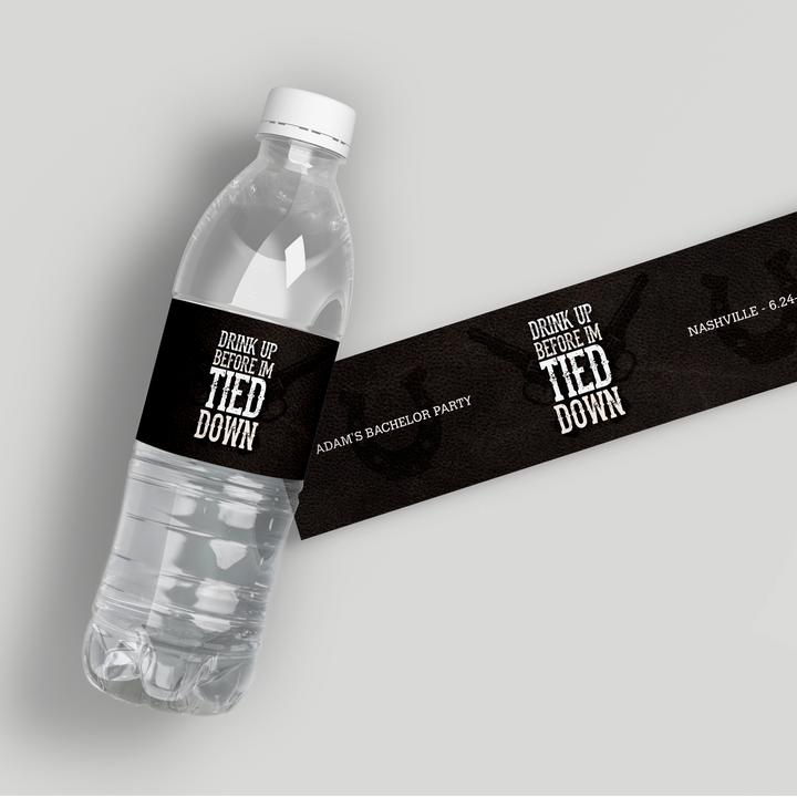 Custom black water bottle label reading 'Drink up before I'm tied down' for Adam's bachelor party in Nashville