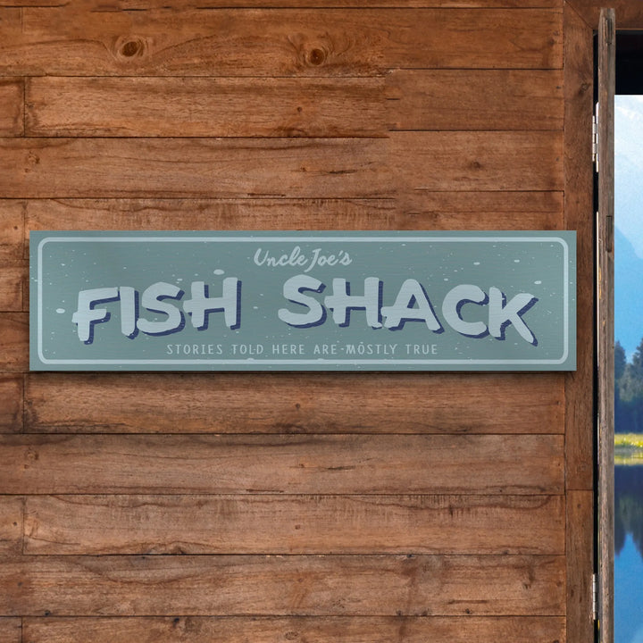 Uncle Joe's Fish Shack rustic metal sign on wooden wall with playful fishing-themed text