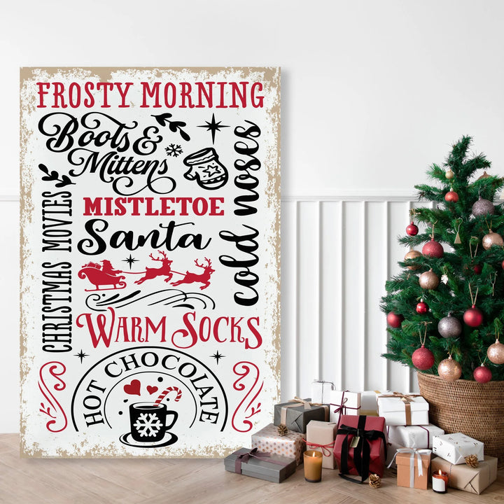 Christmas sign with festive words and images next to decorated Christmas tree and wrapped gifts