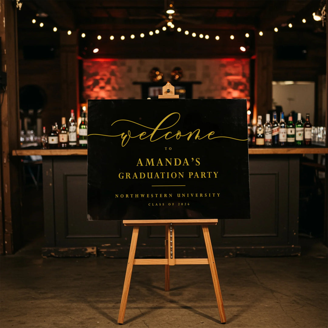 Graduation party welcome sign on an easel in a bar setting