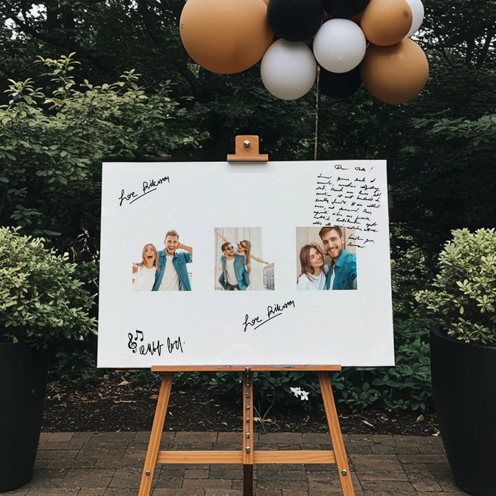 Outdoor wedding guest book board with couple photos, handwritten messages, and balloons