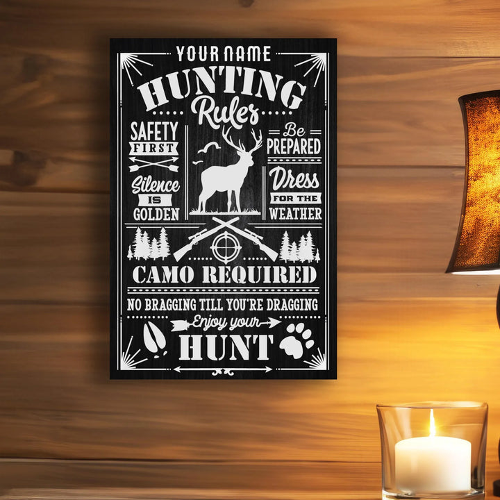 Black metal hunting rules sign with white text, deer silhouette, rifles, and forest icons on wood wall
