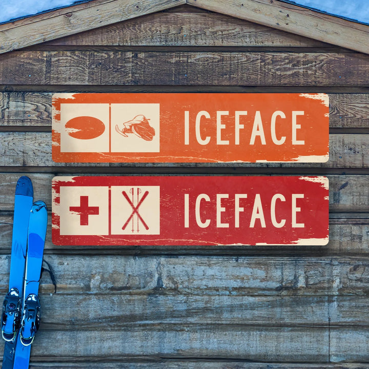Distressed metal ski trail signs labeled ICEFACE with ski and medical symbols on wooden wall with blue skis