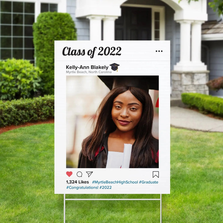 Outdoor graduation yard sign mimicking Instagram post of Kelly-Ann Blakely, Class of 2022, Myrtle Beach, wearing cap and gown