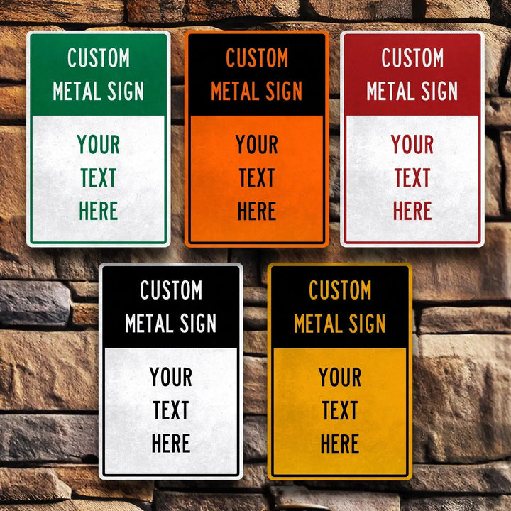 Five custom metal signs in green, orange, red, black, and yellow with text "Your Text Here" on stone wall background