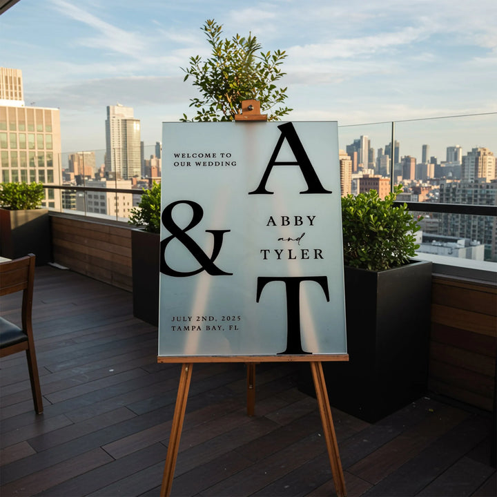 Modern minimal wedding welcome sign for Abby and Tyler on rooftop with city skyline