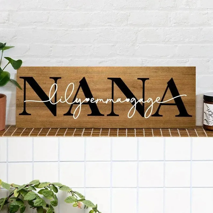 Personalized wood sign with 'NANA' in bold text and names lily, emma, gage in script