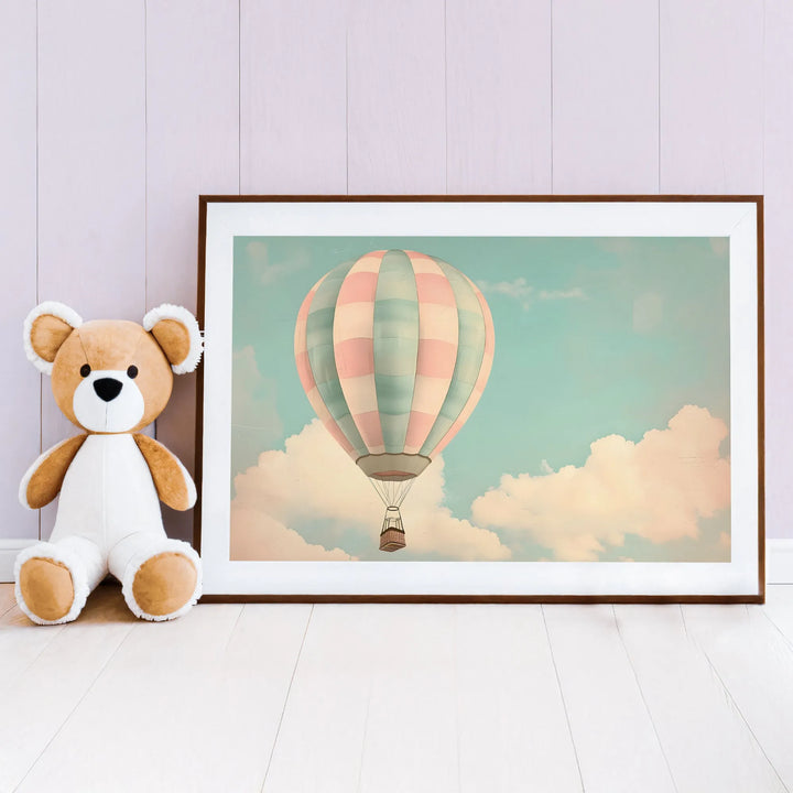 Pastel hot air balloon nursery wall art with soft sky and clouds, next to plush teddy bear