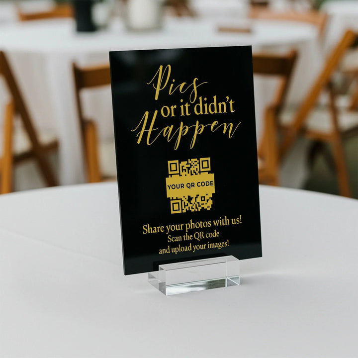 Black and gold wedding table sign with a QR code that reads Pics or it didn't happen