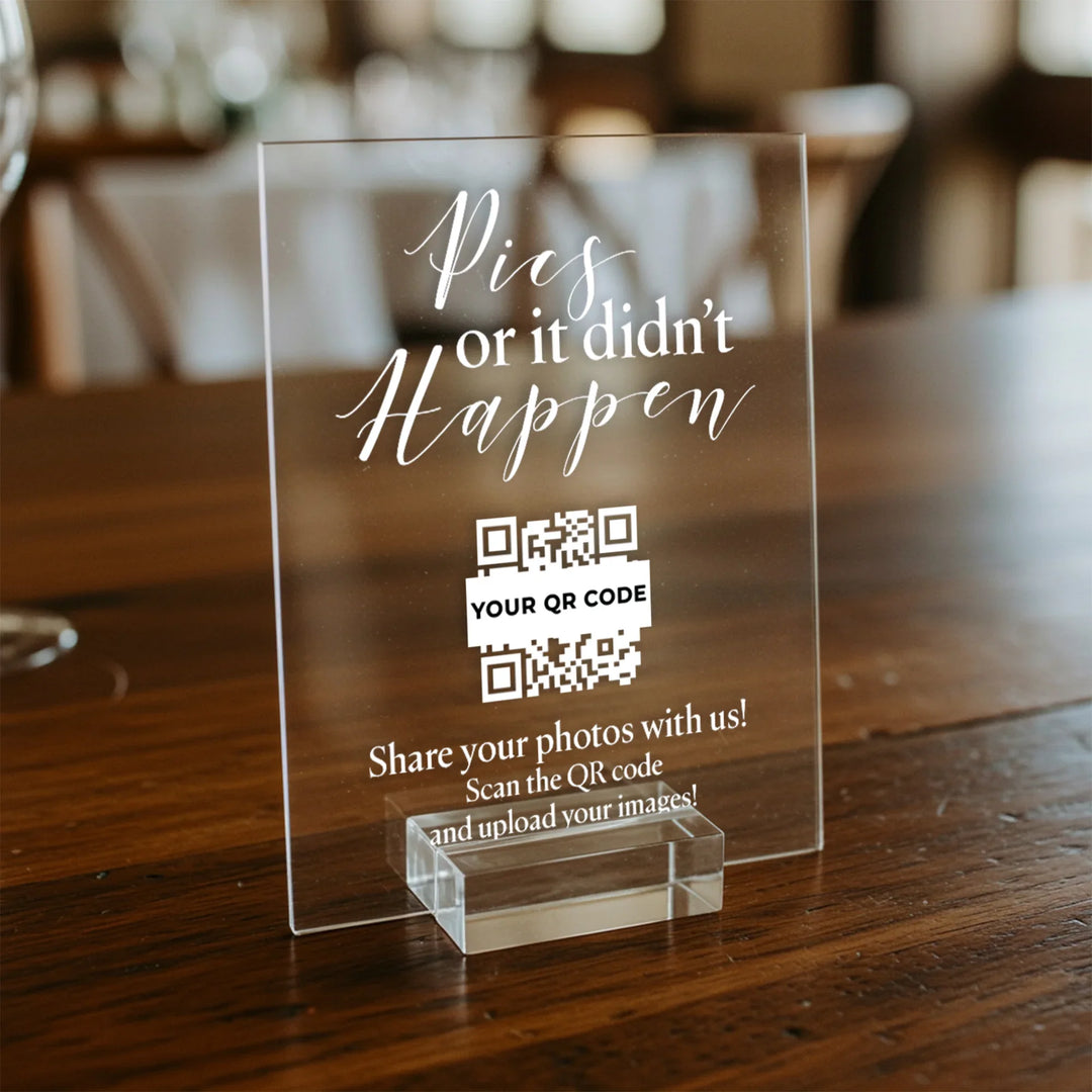 Acrylic wedding table sign with white text 'Pics or it didn't happen' and a QR code for photo sharing