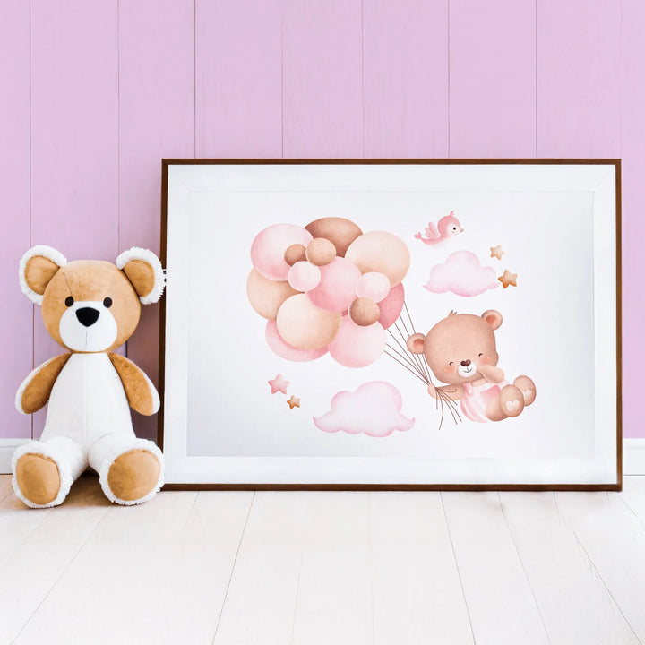 Cute nursery decor featuring teddy bear plush and framed wall art with bear and pink balloons
